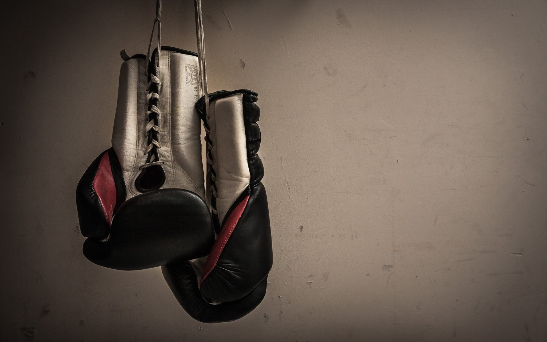 old Boxing Gloves hanging isolated on black Background 957255 Stock Photo  at Vecteezy