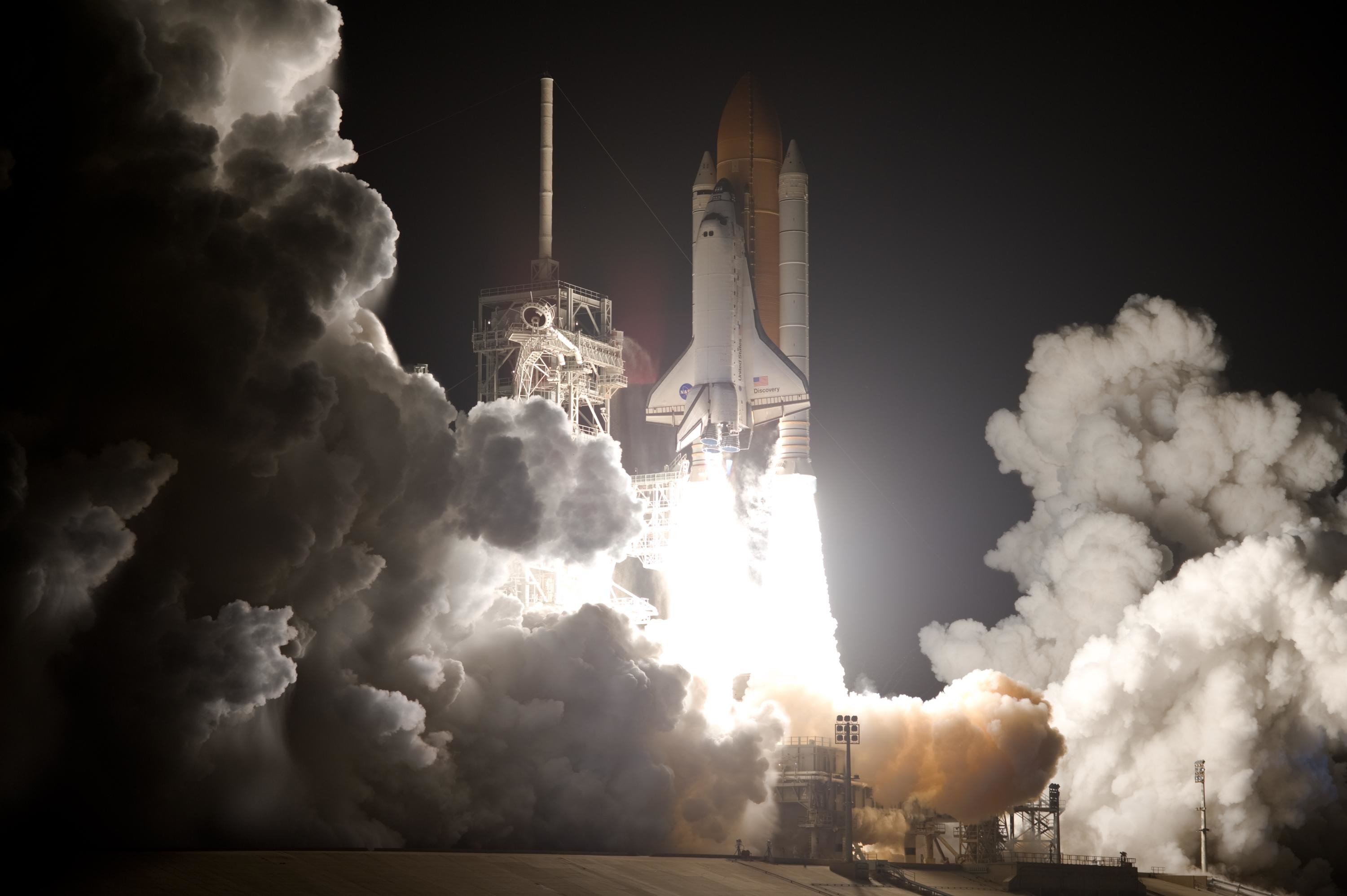 Close view of nighttime shuttle launch with clouds of smoke at bottom of  image 3000x1996